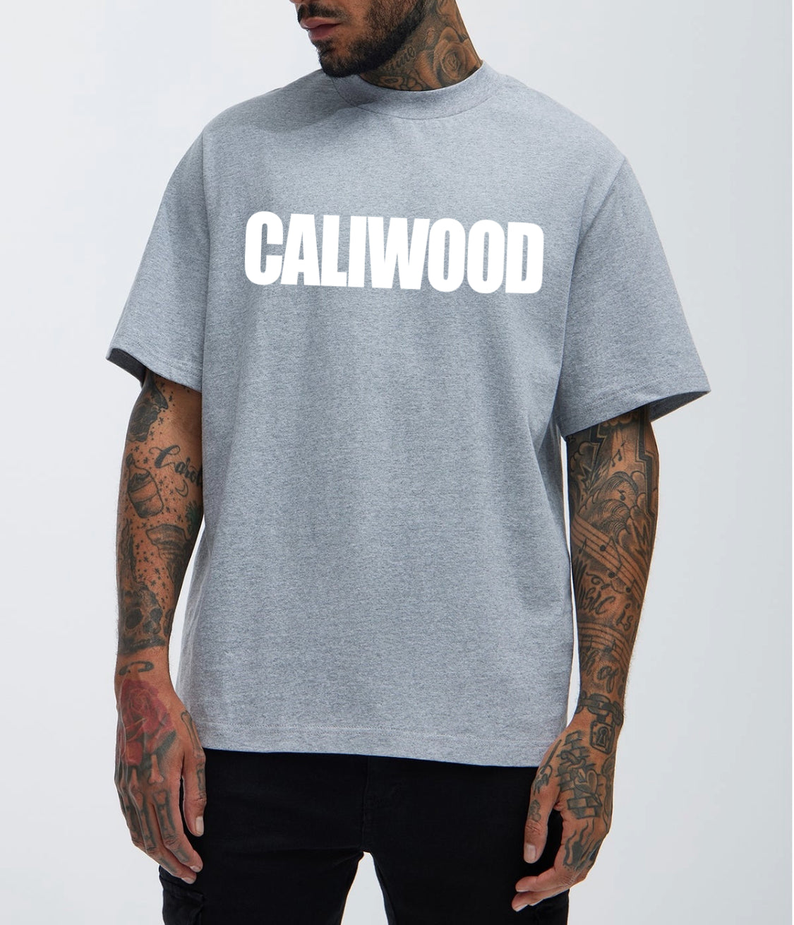 Person wearing a gray t-shirt with 'CALIWOOD' printed on it against a white background