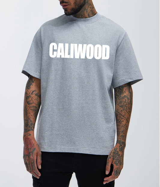 Person wearing a gray t-shirt with 'CALIWOOD' printed on it against a white background